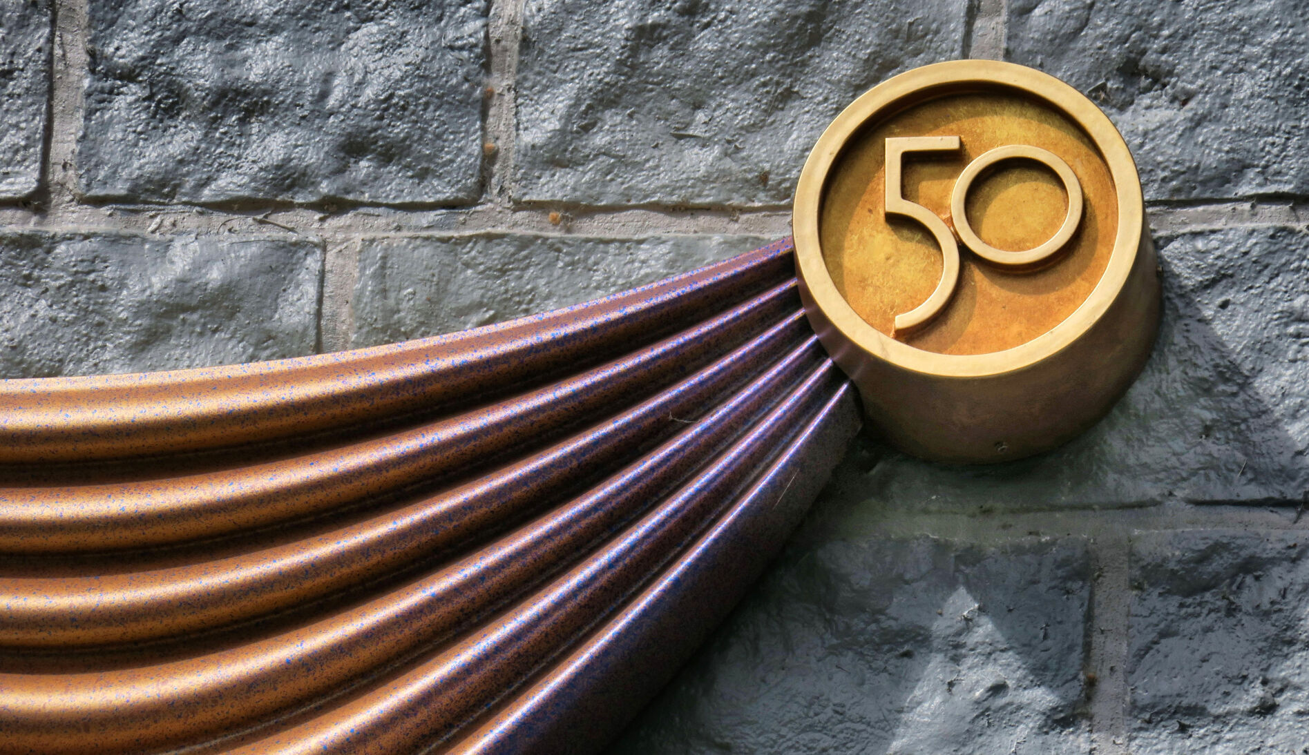 A "50" logo is built into the pin portion of the decorations being added to Cinderella Castle.